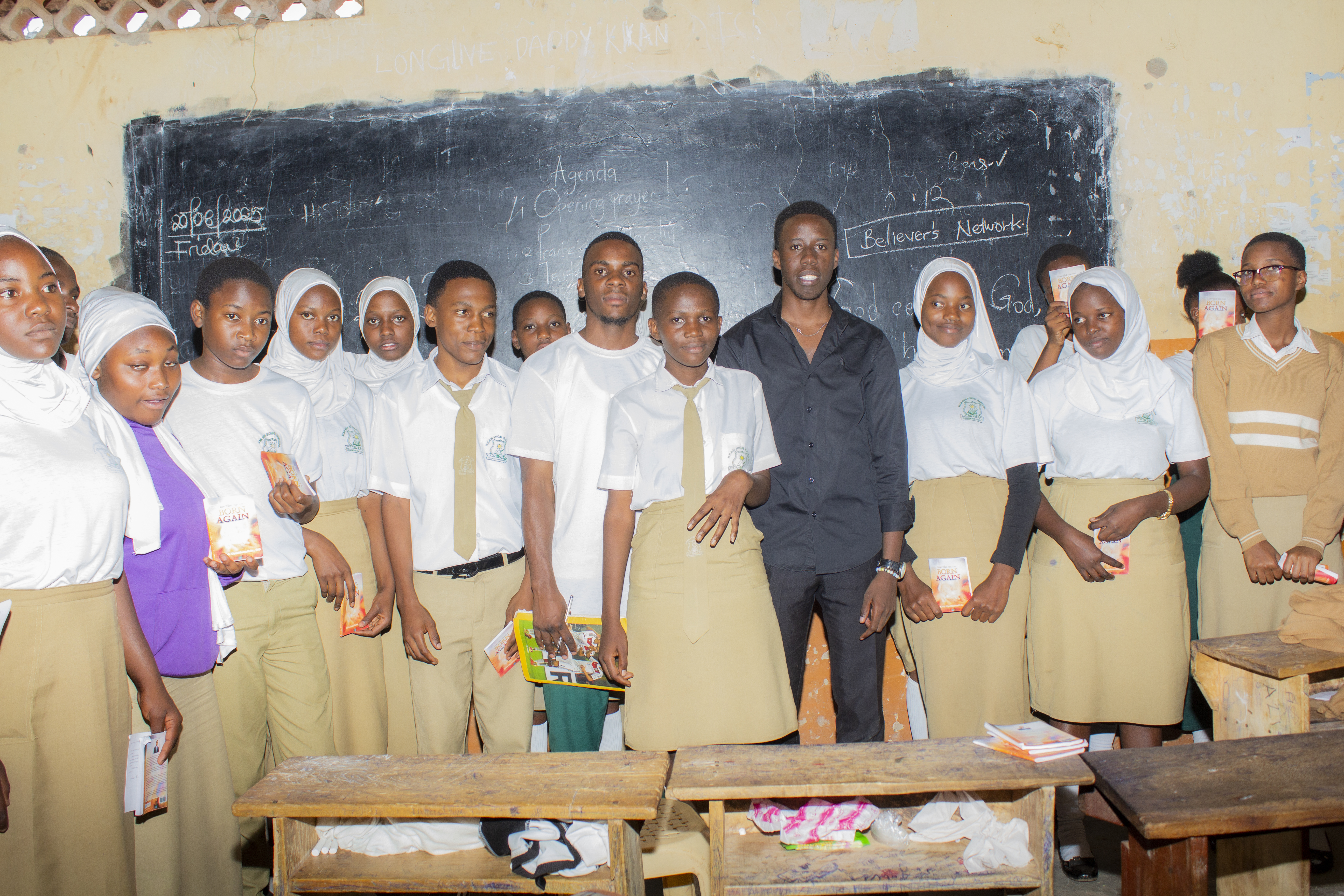 A group of young people praying together at a Believers' Network International event.